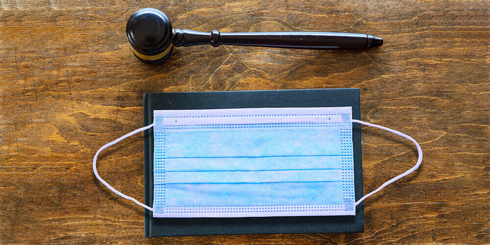 Concept art showing a judge's gavel and a medical mask illustrate the changing expectations of law firms in a post-covid world.