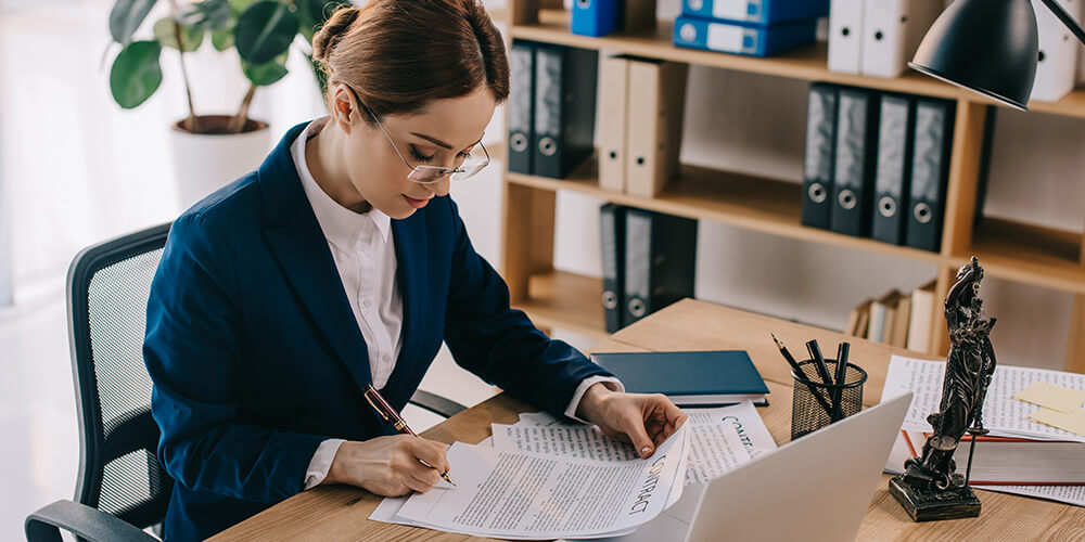 Photo of a lawyer reviewing contracts that were created through document automation and assembly.