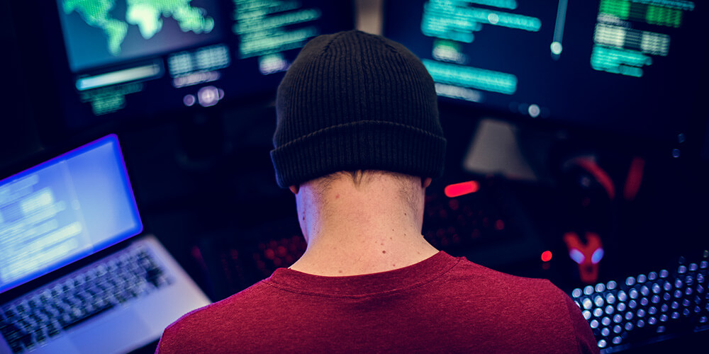 Rear-view photo of the hacker creating the online scam targeting attorneys.