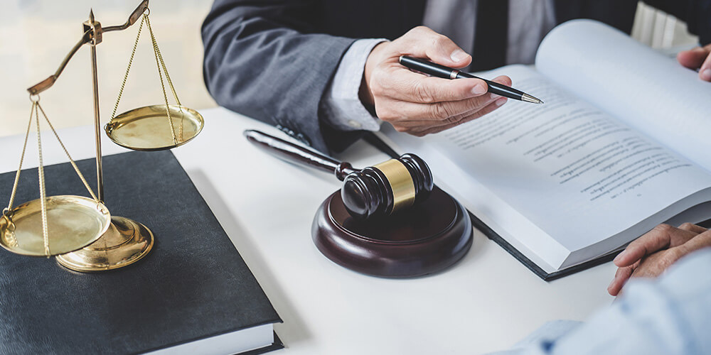 Photo of a lawyer explaining recent trends in class action litigation to his client