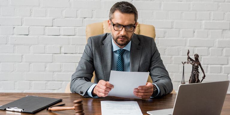 Photo of an attorney working remotely at a desk, following best practices for virtual trial presentation.