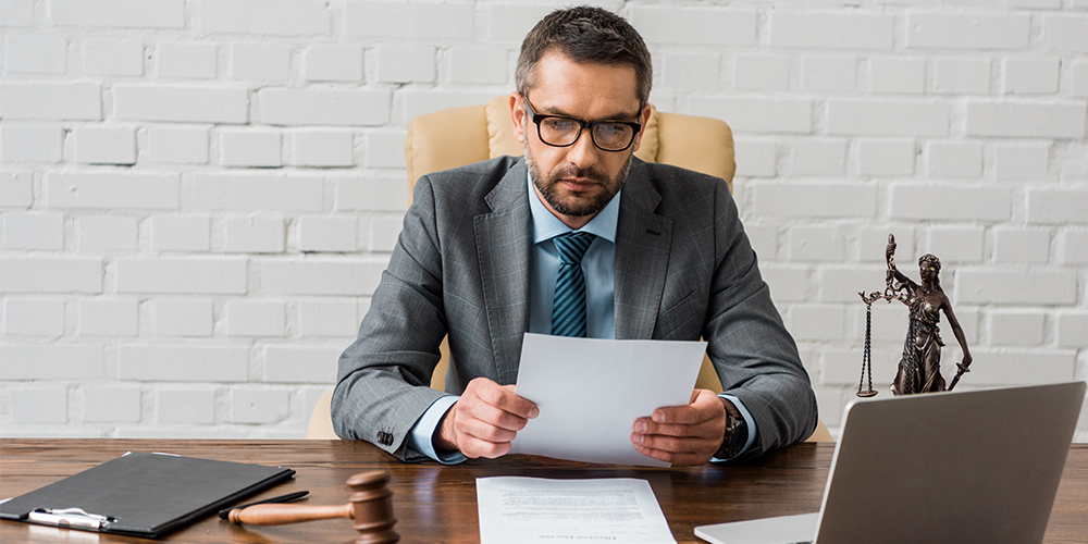 Photo of an attorney working remotely at a desk, following best practices for virtual trial presentation.