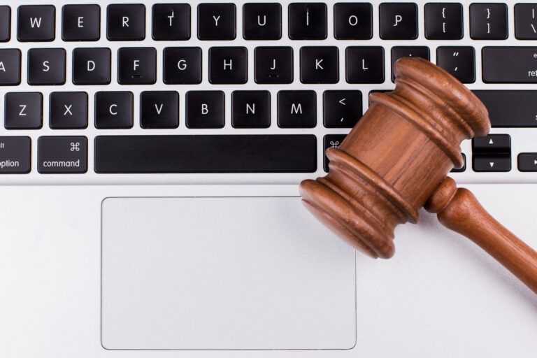 Laptop keyboard with legal gavel on it
